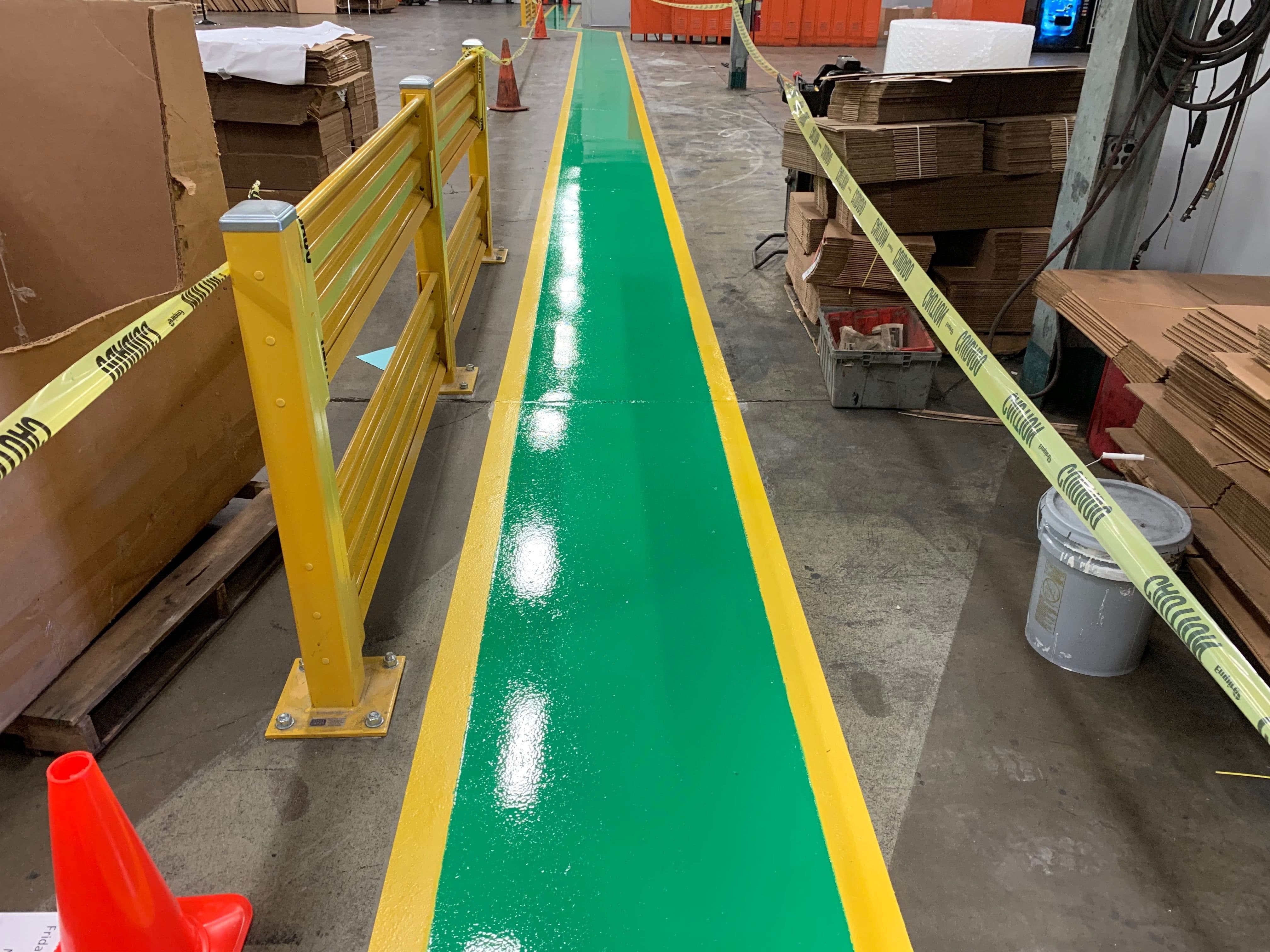 green and yellow pedestrian walkway in warehouse