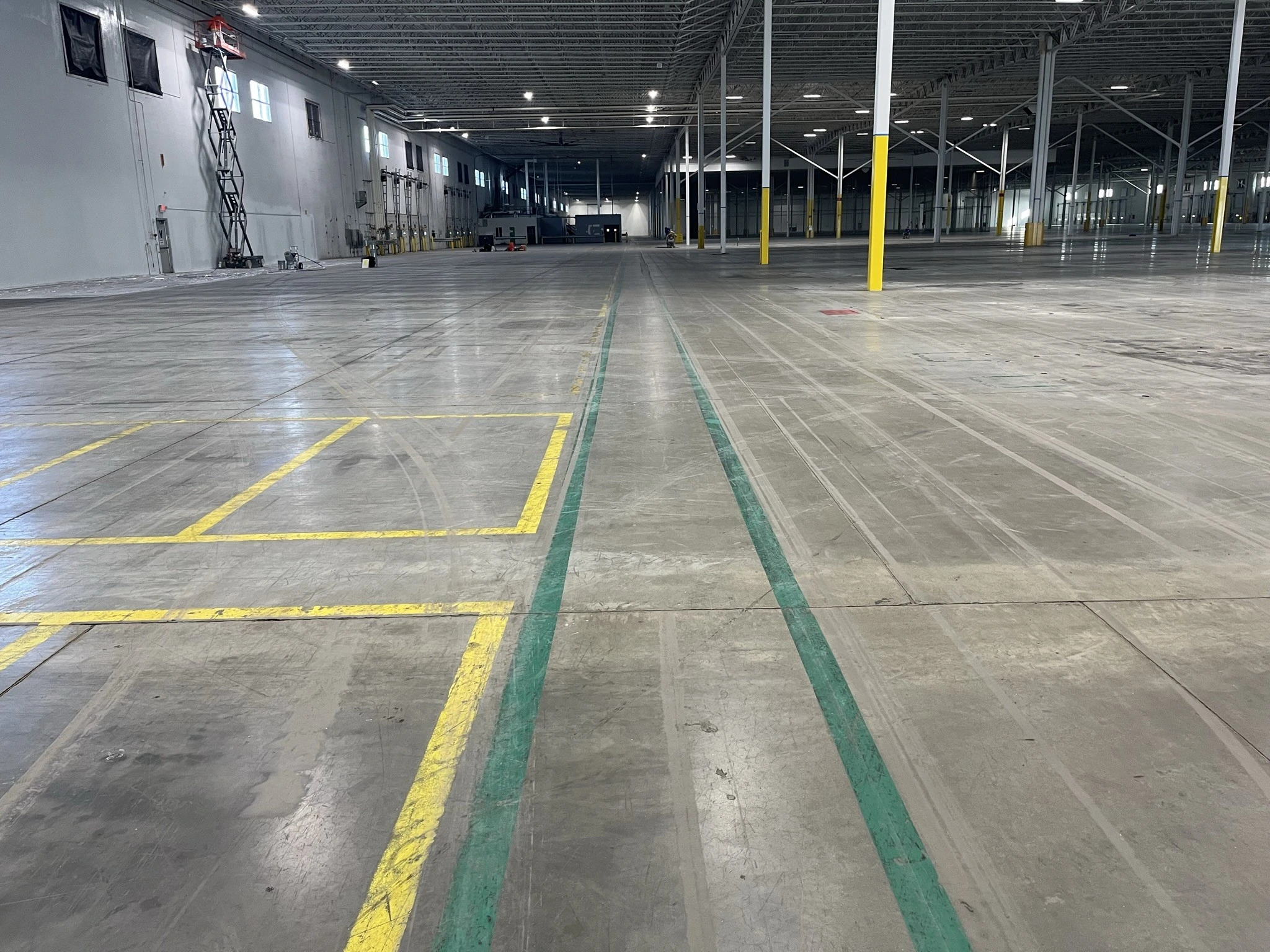 worn down line markings on a warehouse floor